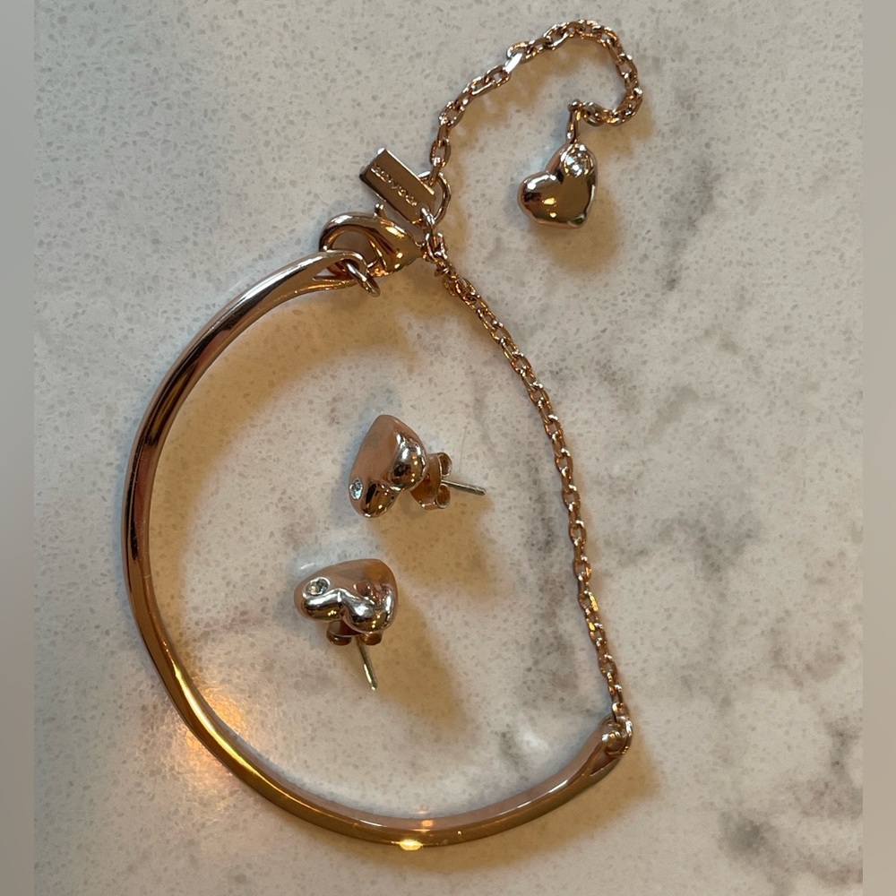 Coach bracelet and earring set.  rose gold color